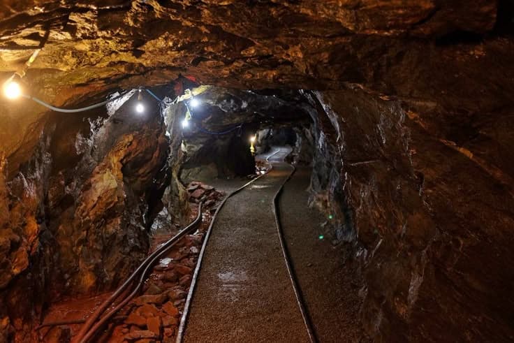 Underground mining tunnel with ground support and industrial lighting
